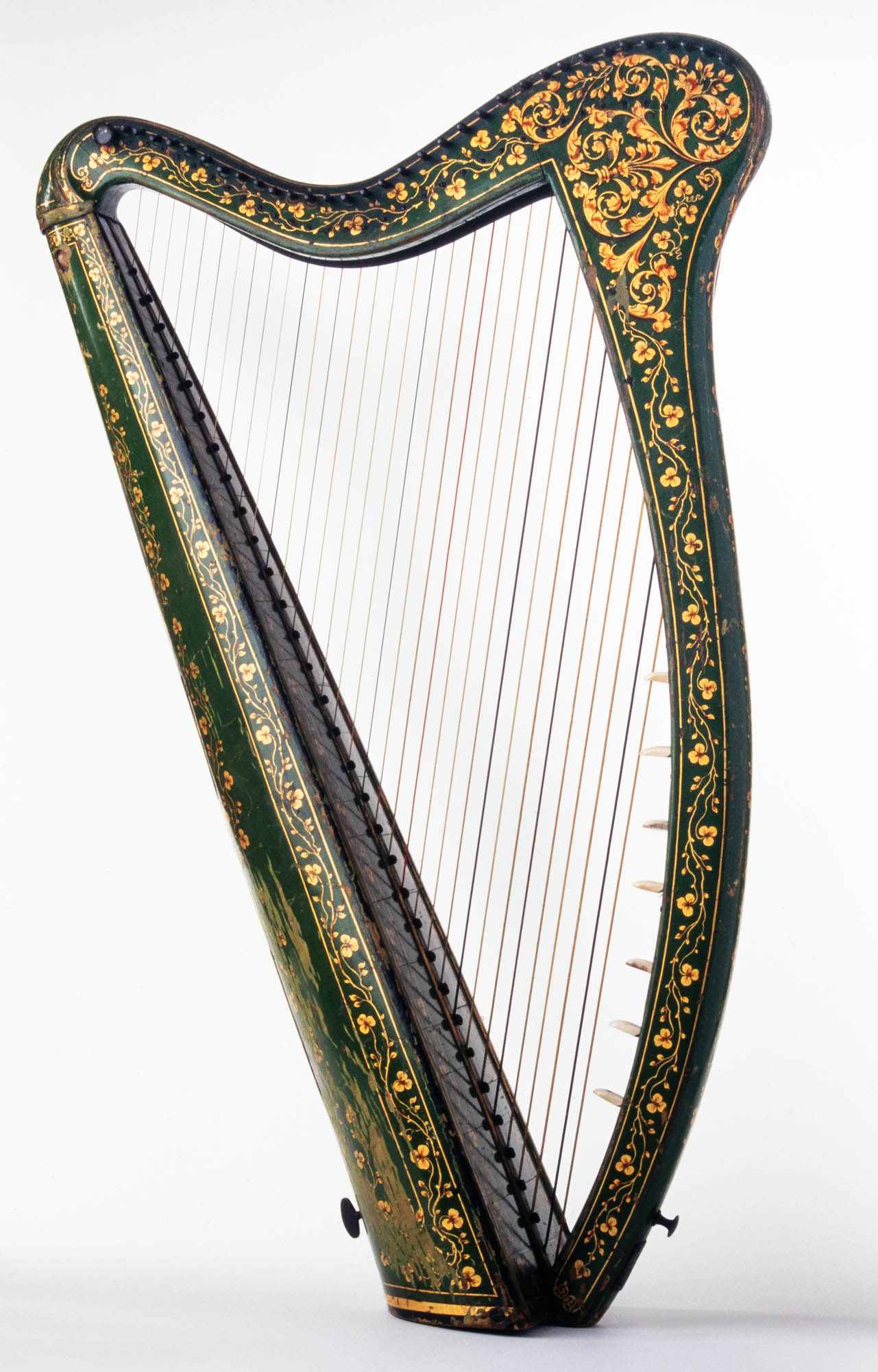 Green harp intricately decorated with arrays of golden shamrocks