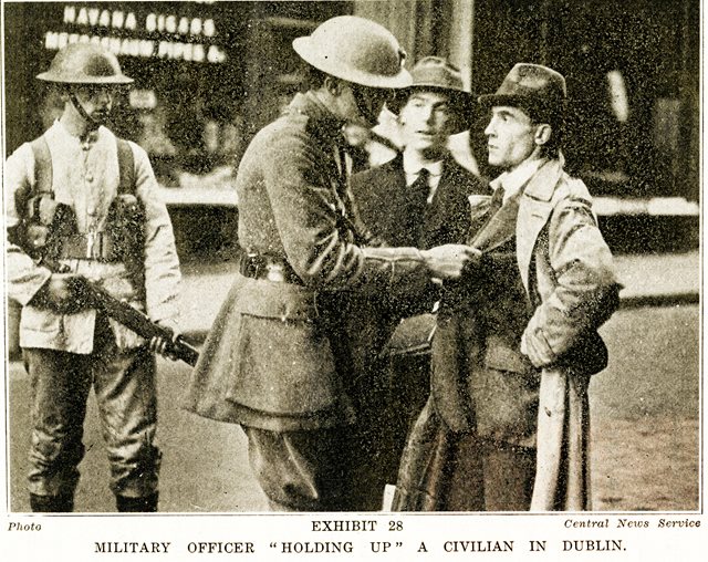 British soldiers holding up a civilian, 1920